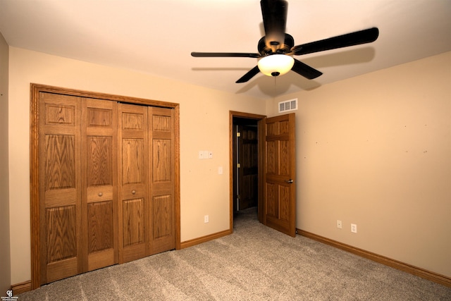 unfurnished bedroom with light carpet, ceiling fan, and a closet