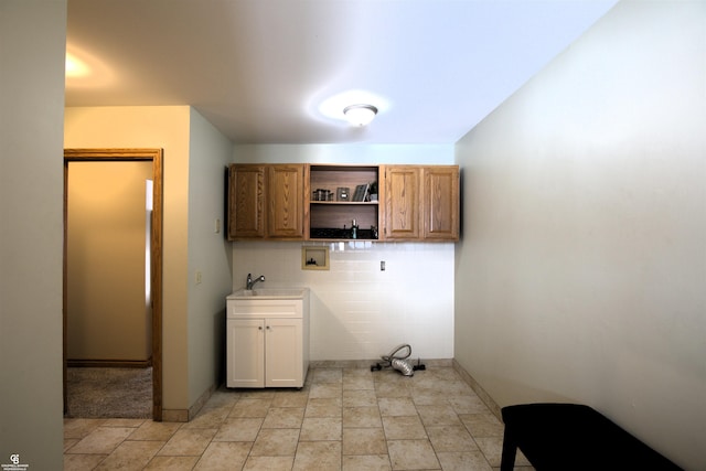 laundry room with washer hookup, sink, and cabinets