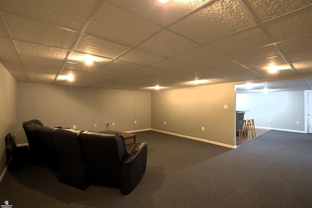 interior space with a drop ceiling and dark carpet