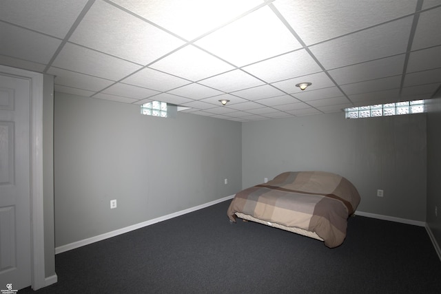 unfurnished bedroom featuring a paneled ceiling and carpet