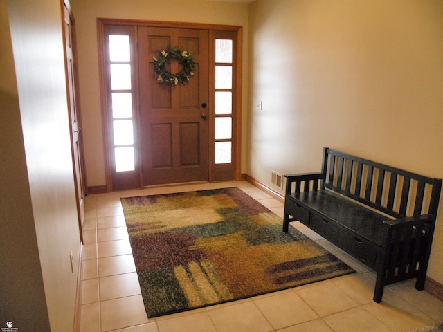 entryway with a wealth of natural light and light tile patterned floors