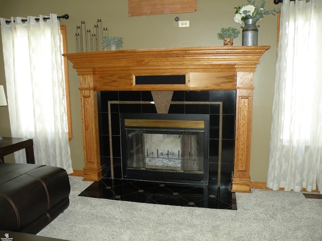 interior details featuring a fireplace and carpet