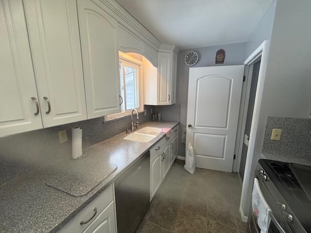 kitchen featuring white cabinetry, decorative backsplash, stainless steel appliances, and sink