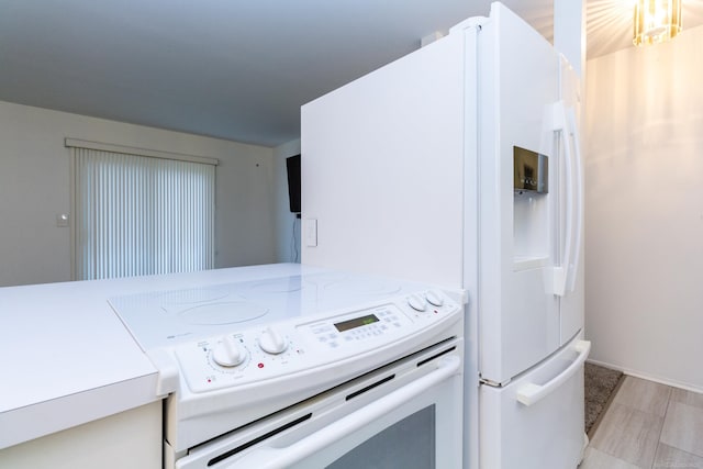 kitchen featuring light stone countertops and white appliances