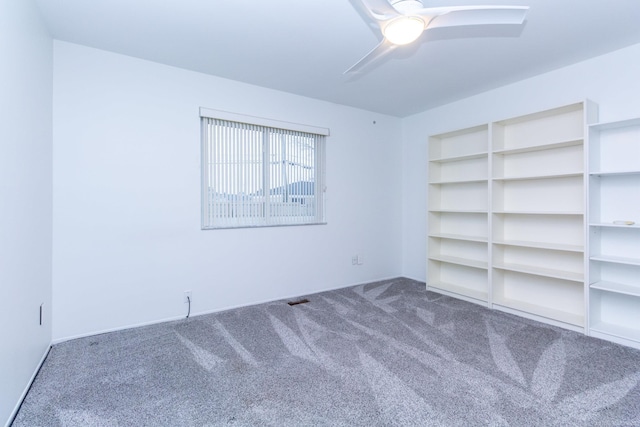 empty room with ceiling fan and carpet