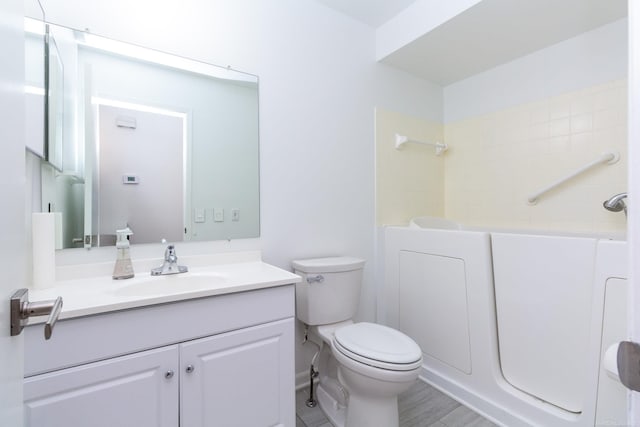 full bathroom featuring toilet, shower / bathtub combination, hardwood / wood-style floors, and vanity