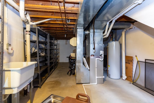 basement featuring sink, heating unit, and gas water heater