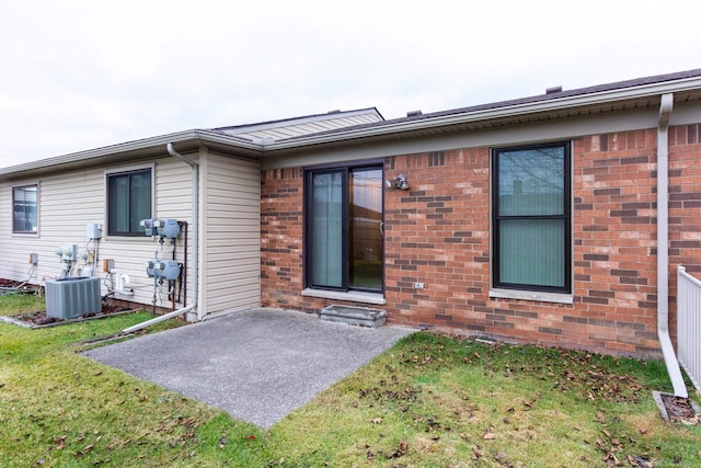 rear view of house with a patio area, cooling unit, and a yard