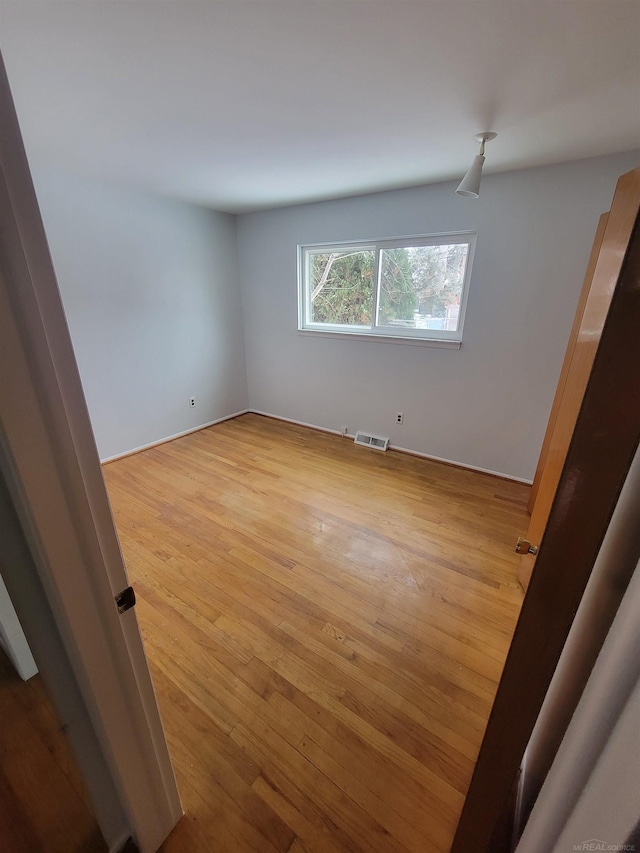 spare room featuring light hardwood / wood-style floors