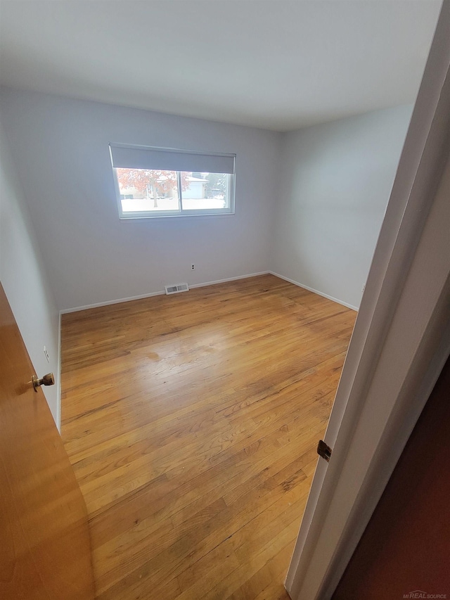 unfurnished room featuring light hardwood / wood-style floors