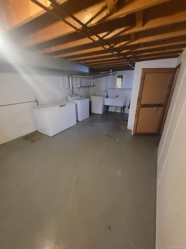 basement with independent washer and dryer, refrigerator, and sink