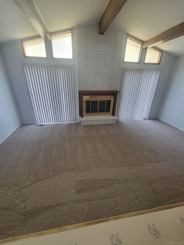 unfurnished living room with carpet flooring, a fireplace, and vaulted ceiling with beams