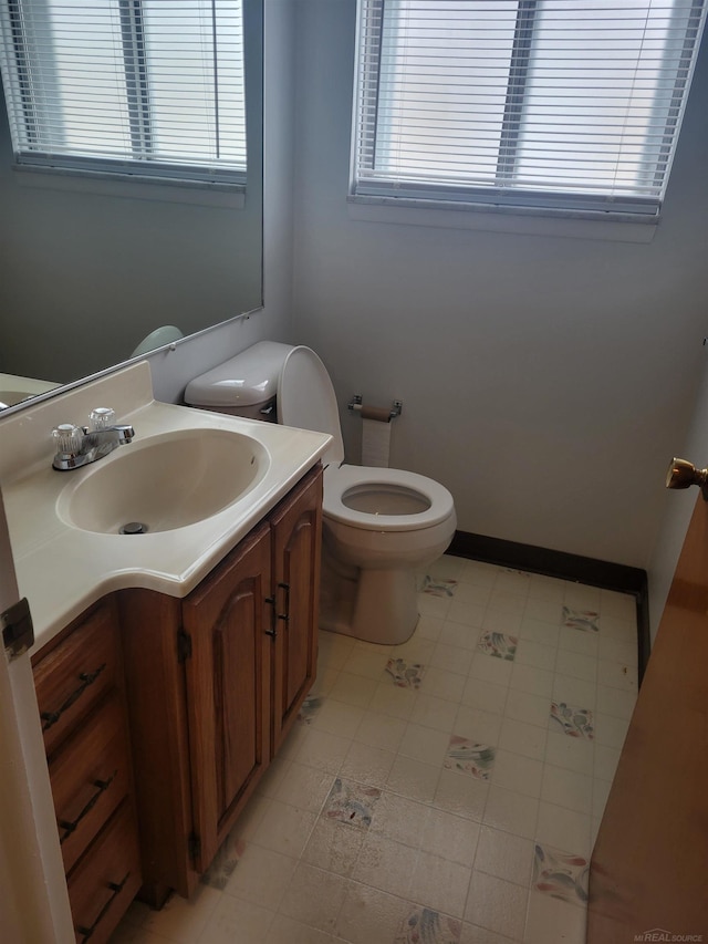 bathroom with vanity, toilet, and tile patterned flooring