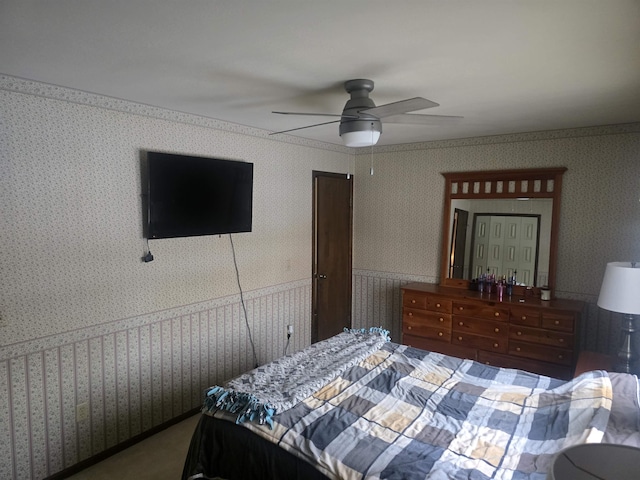 bedroom with ceiling fan and crown molding