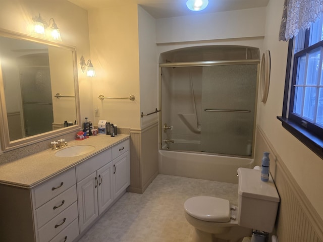 full bathroom with toilet, vanity, and shower / bath combination with glass door