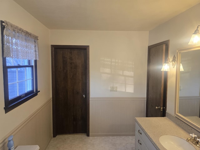 bathroom with vanity and wood walls