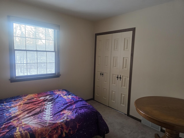 carpeted bedroom with a closet