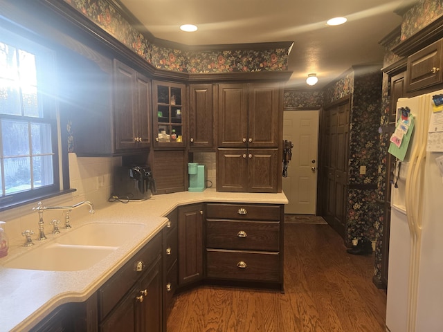 kitchen featuring sink, dark hardwood / wood-style floors, white refrigerator with ice dispenser, and dark brown cabinetry