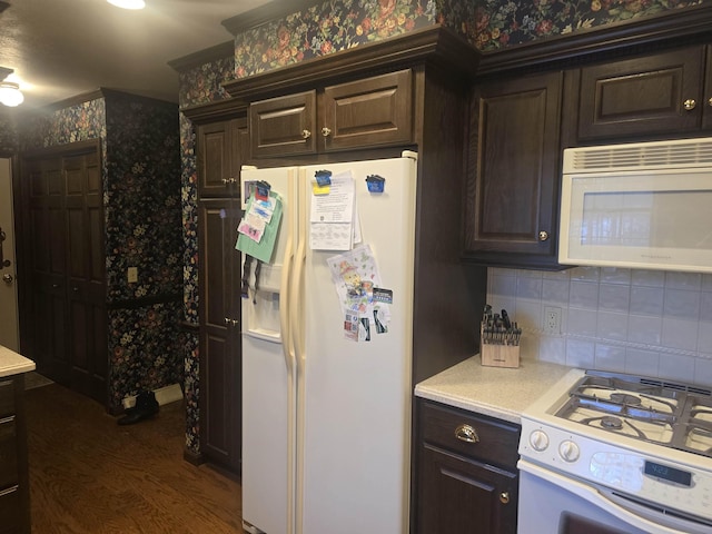 kitchen with decorative backsplash, white appliances, dark hardwood / wood-style floors, and dark brown cabinets