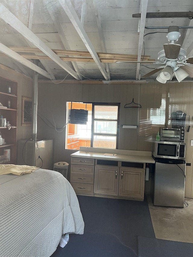 bedroom with ceiling fan, stainless steel fridge, and wooden walls