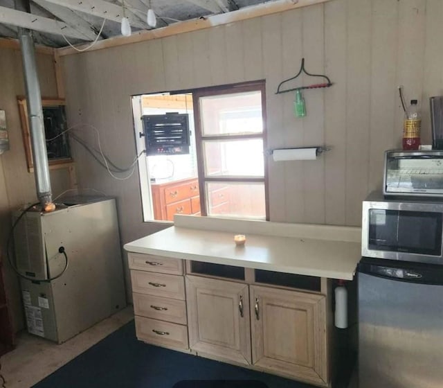 kitchen featuring wood walls and fridge