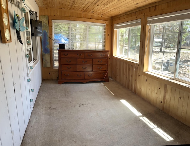 interior space with wood ceiling, wood walls, and multiple windows