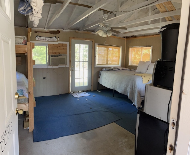 bedroom with lofted ceiling and concrete flooring