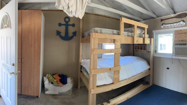 bedroom featuring vaulted ceiling with beams and wooden walls
