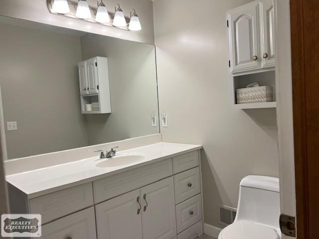 bathroom featuring toilet and vanity