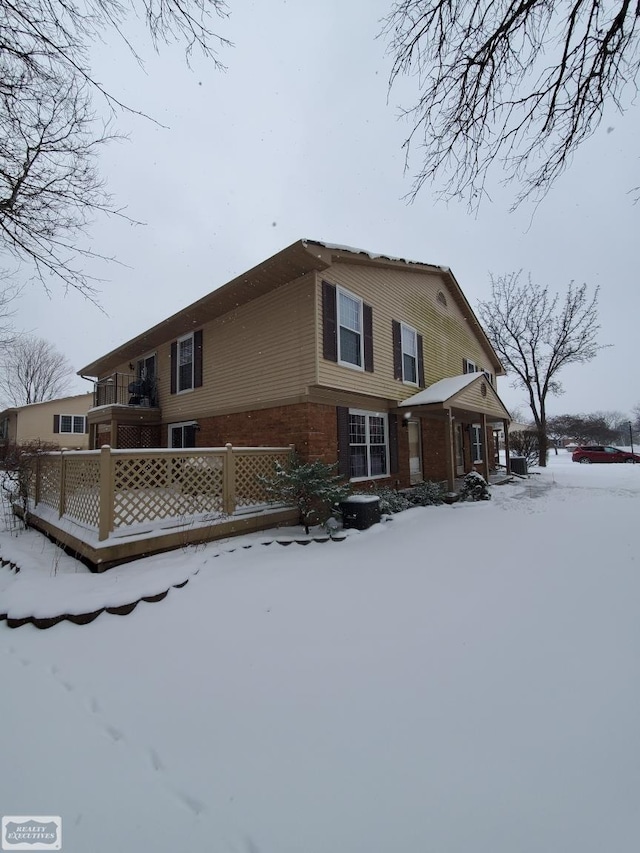 view of snow covered back of property