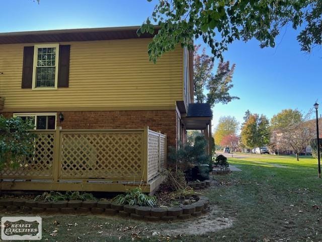 view of side of home featuring a yard