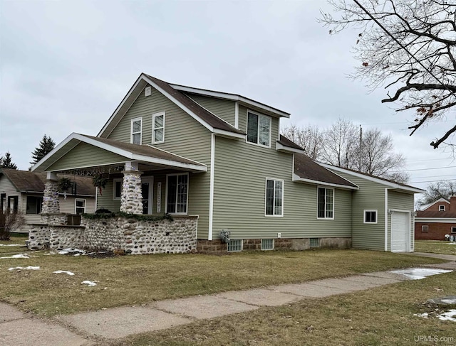 view of side of home with a garage, a lawn, and covered porch