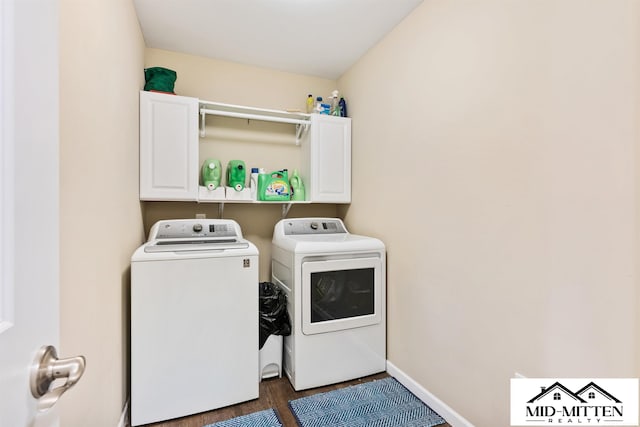 laundry area featuring cabinets and washing machine and clothes dryer