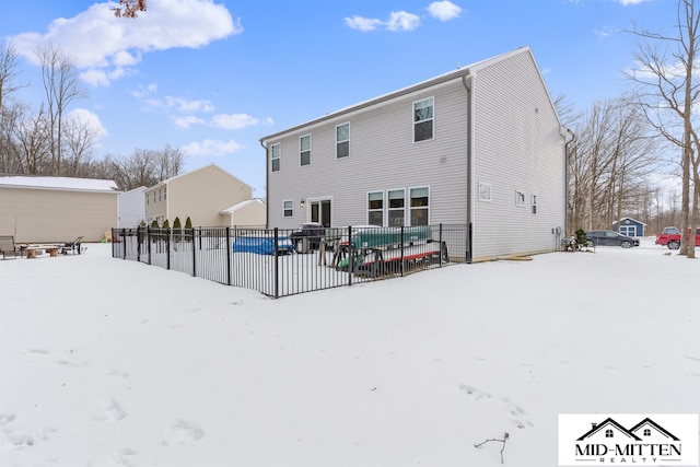 snow covered property with a swimming pool