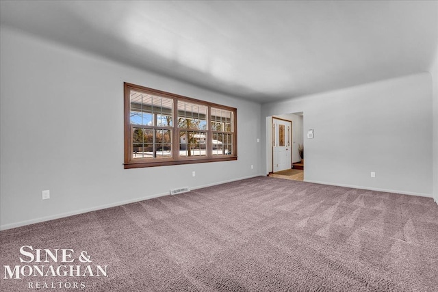 spare room with light colored carpet