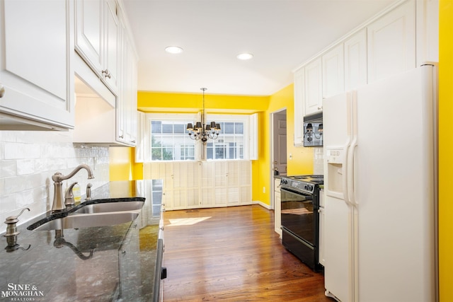 kitchen with pendant lighting, white cabinets, black appliances, dark stone counters, and sink