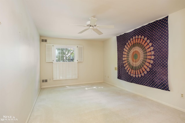 carpeted empty room featuring ceiling fan