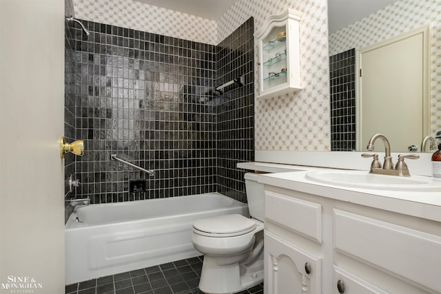 full bathroom with toilet, tiled shower / bath, tile patterned flooring, and vanity