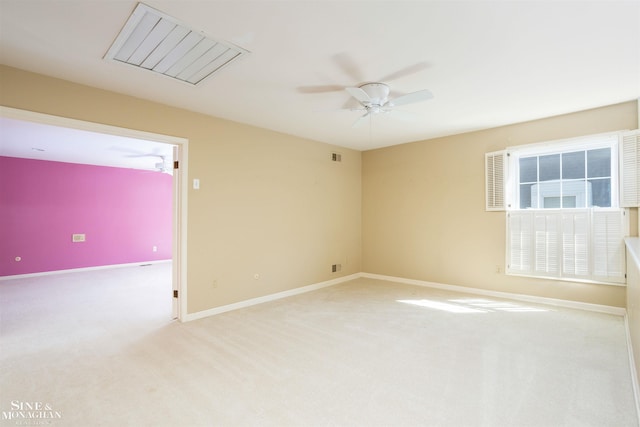 empty room featuring light colored carpet and ceiling fan