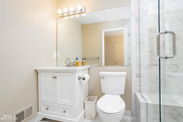 bathroom with vanity, toilet, and an enclosed shower