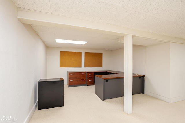 office area featuring light carpet and a paneled ceiling