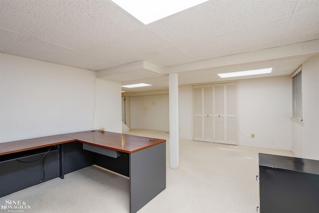 unfurnished office with a paneled ceiling