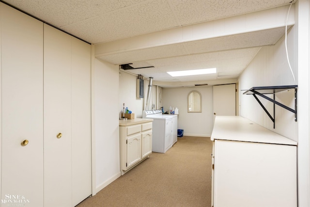 laundry area featuring light colored carpet and washer and dryer