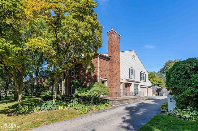 view of property exterior featuring a yard and a garage