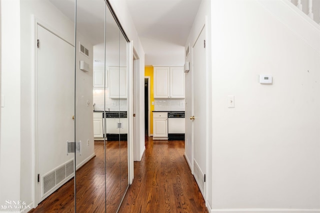 hall with dark hardwood / wood-style flooring