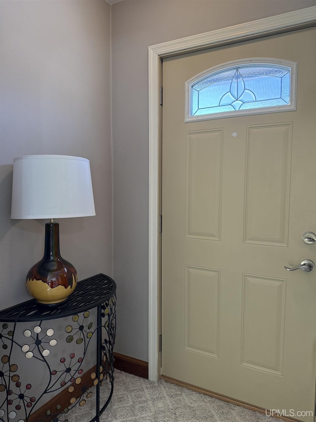 foyer entrance with light carpet