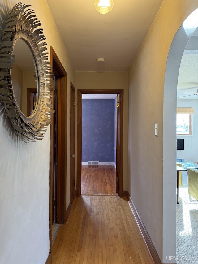 corridor with wood-type flooring