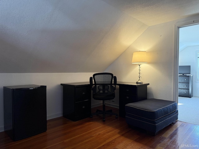 office space with a textured ceiling, dark hardwood / wood-style floors, and vaulted ceiling