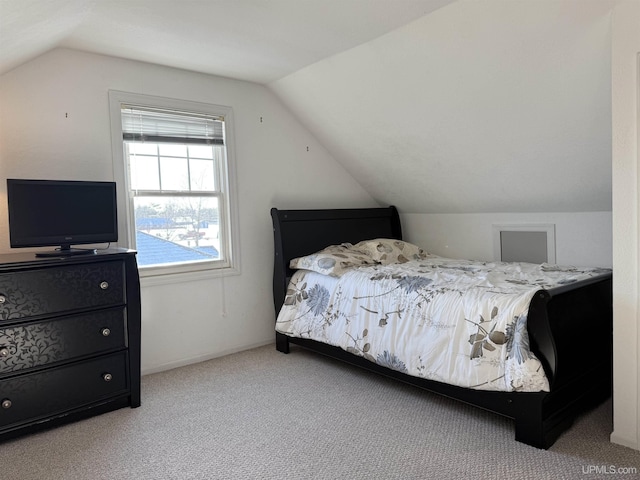 carpeted bedroom with lofted ceiling