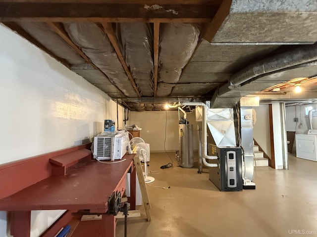 basement featuring heating unit, gas water heater, and washer / clothes dryer